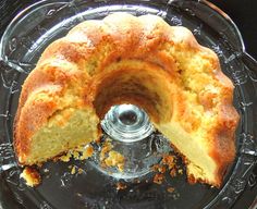 a bundt cake sitting on top of a glass plate covered in crumbs