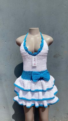 a mannequin wearing a white and blue crochet swimsuit on display