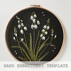 a hand embroidery pattern with white flowers and green stems on a black background, in the hoop