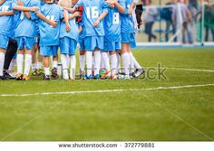 the soccer team is huddled together on the field for a huddle before their game