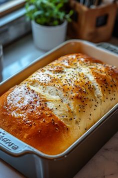 Freshly baked loaf of bread in a baking pan, topped with sesame seeds and crispy golden crust. Homemade Bread Machine Recipes Easy, How To Make Bread In Bread Machine, 3 Pound Bread Machine Recipes, Sweet Bread Maker Recipes Easy, Mediterranean Bread Machine Recipes, Bread Machine Bread Dough, Sugar Free Bread Machine Recipes, Homemade Bread Bread Machine, Homemade Bread Machine Recipes