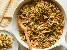 a white bowl filled with rice and vegetables