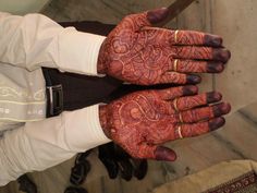 two hands that are covered in henna