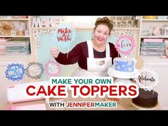 a woman holding two cake toppers in front of a table with cakes on it