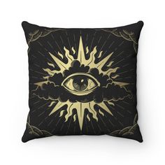 a pillow with an all seeing eye in the center and flames coming out of it