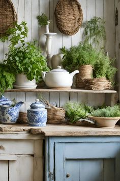 an assortment of herbs on shelves in a kitchen with blue and white pots, wicker baskets hanging from the wall