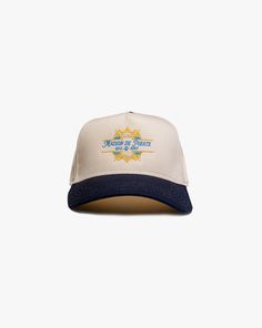 Maison de Pirate Hat Size: Adjustable Cap Color: Cream/Navy Blue Front Maison De Pirate Design Embroidery Stitch Count: 7,162 Embroidery Color: Gold, Cream, Light Blue, White Embroidered Cream Cap, Cream Embroidered Cap, Beige Summer Hats With Embroidered Logo, Adjustable Cream Hat With Embroidered Logo, Navy Embroidered Logo Trucker Hat, Navy Trucker Hat With Embroidered Logo, Navy Visor Hat With Embroidered Logo, Navy Spring Cap, Navy Embroidered Cap