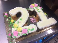 a birthday cake that has the number twenty two on it with flowers and icing