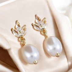 ✨ Attention: Elevate your elegance with our stunning Sterling Silver & Gold Pearl Diamond Earrings! Designed to captivate, these earrings combine the timeless beauty of real freshwater pearls and sparkling diamonds with a unique leaf design--perfect for brides or as a luxurious gift. 🌿💎 🌟 Interest: Handcrafted with precision, these earrings offer a delicate balance of sterling silver and gold accents, making them versatile for any occasion. Whether you're walking down the aisle or adding a to White Teardrop Earrings With Elegant Design For Gifts, White Crystal Earrings With Elegant Design For Gift, White Crystal Earrings With Elegant Design For Anniversary, Classic White Flower Earrings For Wedding, Classic White Flower Wedding Earrings, Elegant Teardrop Flower Earrings For Jewelry Making, Pearl Diamond Earrings, Pearl And Diamond Earrings, Gold Diamond Earrings