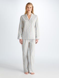 Designed for a flattering but comfortable shape, our Amalfi pyjamas will keep you looking great and feeling comfortable all year round. Made from a striped blue and sand cotton batiste, the Amalfi jacket features a fully piped finish in a white trim, a single patch pocket and buttons. The quality of craftsmanship continues with the trousers and their elasticated waist with self fabric drawstrings for added comfort. A firm favourite of our customers for its breathability, lightweight properties a Short Gown Dress, Batiste Fabric, Cashmere Loungewear, Holiday Capsule Wardrobe, Cotton Dressing Gown, Luxury Nightwear, Silk Dressing Gown, Derek Rose, Cotton Pajama Set