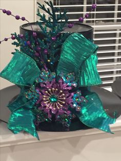 a green and purple christmas tree on top of a table