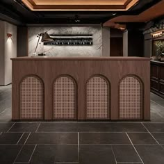 an elegant bar in the middle of a room with black tile flooring and walls