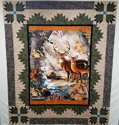 a quilt with two deer standing next to each other on it's wall hanging