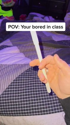 a person holding a toothbrush in their hand with the text pov your bored in class