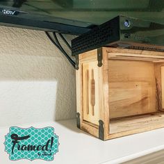 a wooden box sitting on top of a white shelf