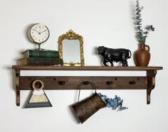 a shelf that has various items on it and a cow figurine next to it