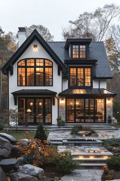 a white house with lots of windows and steps leading up to the front porch area