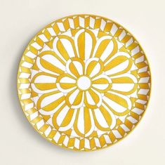 a yellow and white plate sitting on top of an orange frame with the words hermes paris