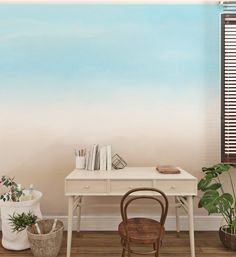 a room with a desk, chair and potted plants on the floor in front of it