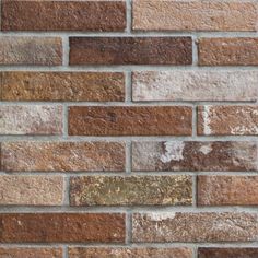 an old brick wall with brown and tan bricks