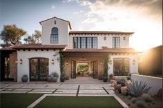 a large white house with lots of windows and plants in the front yard at sunset