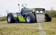 a tractor is parked in the middle of a grassy field with an antenna attached to it