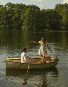 two people in a boat on the water with one person pointing at something to another