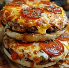 three cheeseburgers stacked on top of each other with toppings like pepperoni and tomatoes