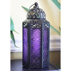 a purple lantern sitting on top of a table