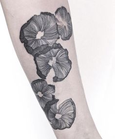 a black and white photo of flowers on the arm