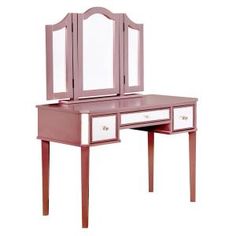 a pink dressing table with mirror and drawers on the bottom shelf, in front of a white background