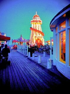 the boardwalk is lit up with colorful lights