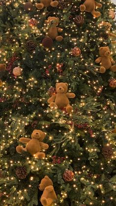 a christmas tree with lights and teddy bears on it