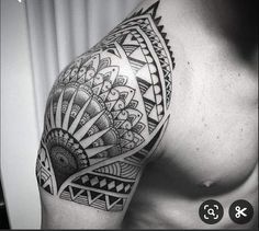 a black and white photo of a man's arm with an intricate tattoo design on it