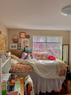 two children are sitting on the bed in their room, reading books and having fun with each other