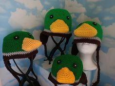 four crocheted hats with birds on them