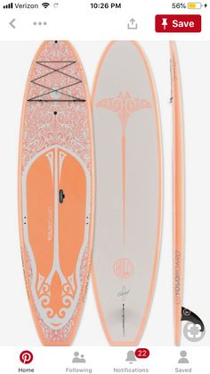 an orange and white surfboard next to a paddle board