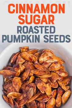 roasted pumpkin seeds in a white bowl with the title cinnamon sugar roasted pumpkin seeds