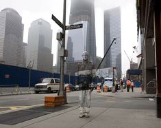 there is a statue on the street corner in front of some tall buildings and cars