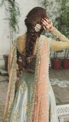 the back of a woman's dress, with long hair in an intricate braid