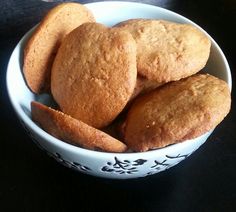 a white bowl filled with cookies on top of a table