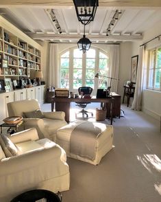 a living room with lots of furniture and bookshelves