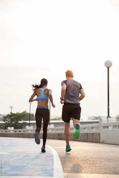 two people are running on the street