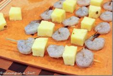 shrimp and pineapple skewers on a cutting board