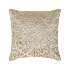 a gold and white pillow with an intricate design on the front, in shades of beige