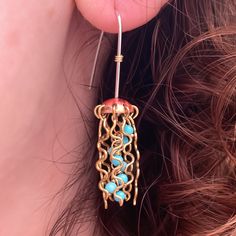 These jellyfish earrings are made from copper tops, brass legs, turquoise centers and sterling silver ear wires. These are the mini version of our regular jellyfish earrings. They hang 1.75" long are are just over 0.25" across. Jellyfish Earrings, Ocean Earrings, Brass Legs, New Crafts, Copper Earrings, Jewelry Inspo, Turquoise Beads, Jellyfish, Designer Earrings