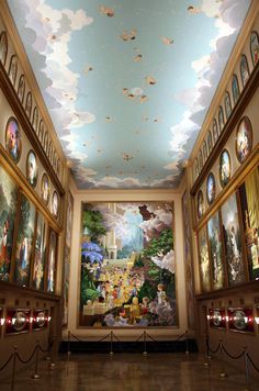 the ceiling is decorated with paintings and lights