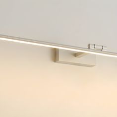 a white wall light with two lights on it's sides and one is off