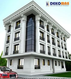 a large white building with windows and balconies on the second floor, next to a red car