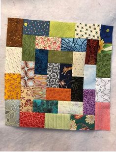 a patchwork quilt with many different colors and patterns